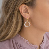 Gold plated hoop earrings with pearl sunburst detailing, adding texture and interest to everyday styling