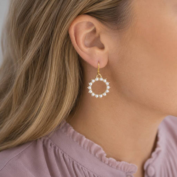 Gold plated hoop earrings with pearl sunburst detailing, adding texture and interest to everyday styling