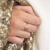 Images shows model with gold sequin jacket wearing a cancer zodiac ring