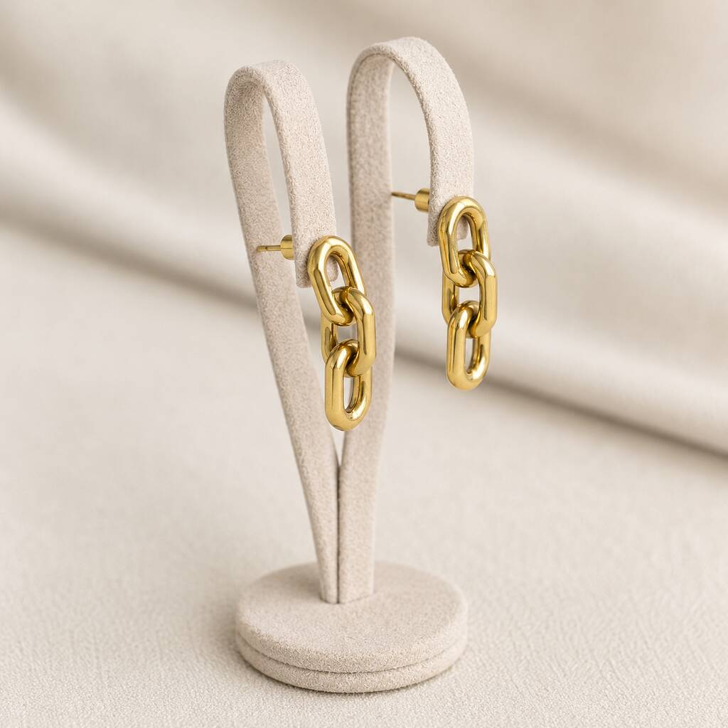 Statement chain drop earrings in polished gold plating, highlighting their elongated link design and sleek finish
