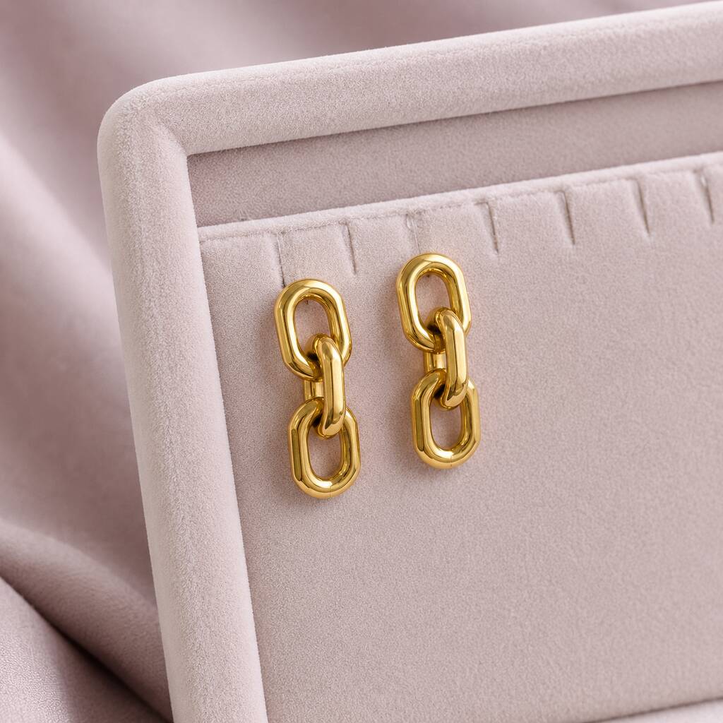 Polished gold chain link earrings with rounded open links, creating a bold yet refined statement accessory
