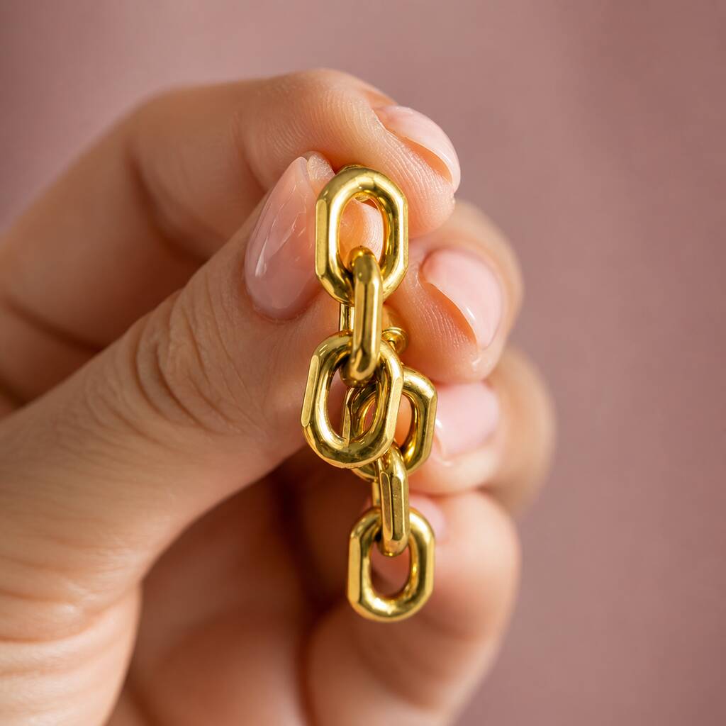 Detailed view of gold plated chain drop earrings with smooth rounded links and a high-shine finish for statement styling
