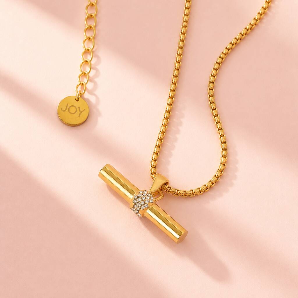 Gold plated T bar pendant necklace on a textured chain, adding a modern edge to layered jewellery looks