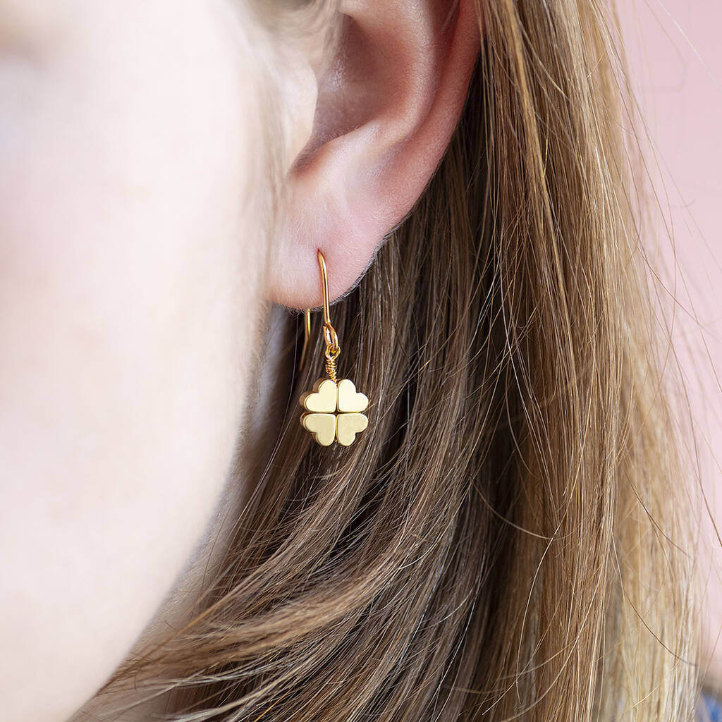 Gold plated four leaf clover earrings worn in the ear lobe