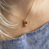 Model wears Gold Plated Initial and Birthstone Star Necklace 'A' with July Ruby