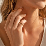 Gold plated crossover ring with pavé crystal accent, styled on hand for a modern stacked jewellery look
