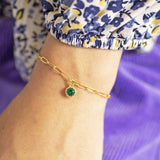 Model wears Gold Plated Ornate Round Birthstone Bracelet with a May emerald birthstone