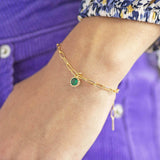 Model wears Gold Plated Ornate Round Birthstone Bracelet with a May emerald birthstone