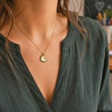 Gold pencil shaving pendant necklace styled with green blouse, quirky statement jewellery for everyday wear
