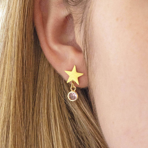 Model wears Gold Plated Star Birthstone Earrings with October rose birthstone.