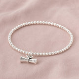 Silver plated beaded charm bracelet with graduation scroll charm, perfect for stacking and everyday wear.