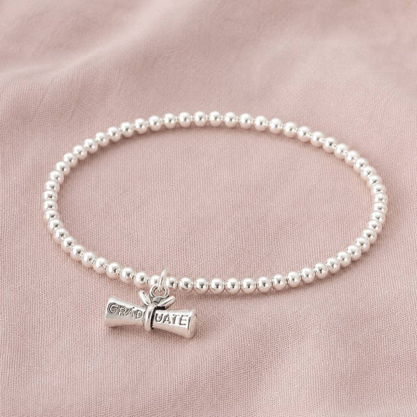 Silver plated beaded charm bracelet with graduation scroll charm, perfect for stacking and everyday wear.