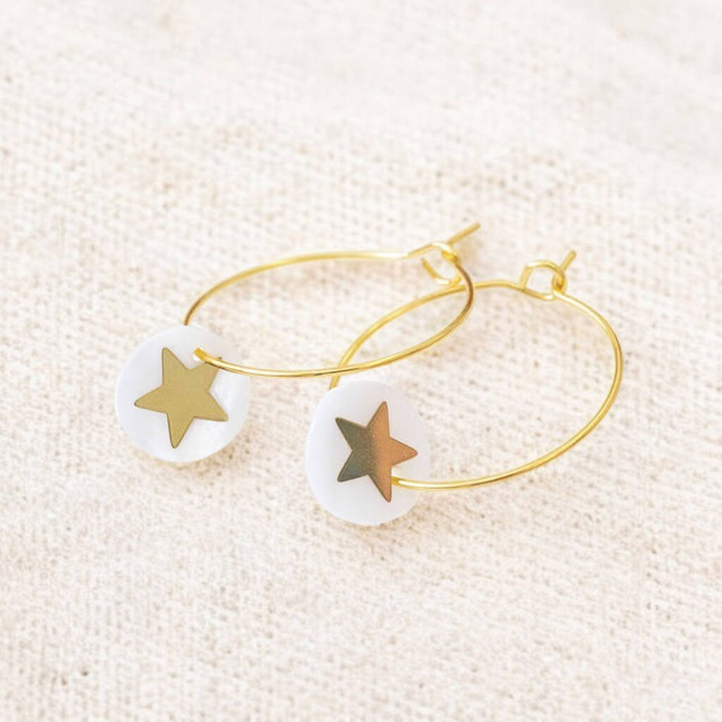 Image shows gold hoop earrings with a Mother of Pearl round disc featuring a gold star.