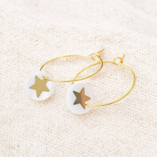 Image shows gold hoop earrings with a Mother of Pearl round disc featuring a gold star.