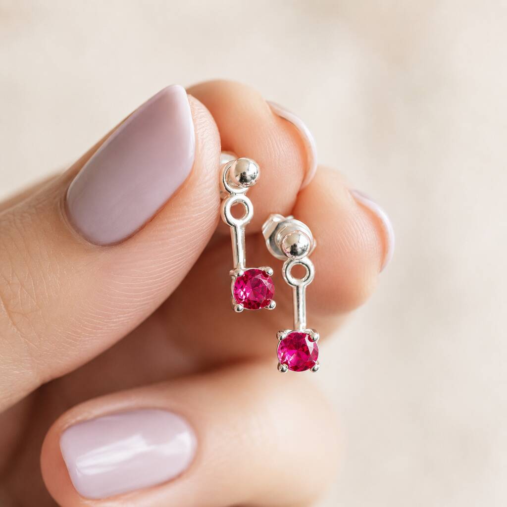 Silver plated drop stud earrings with vivid pink birthstone crystals, designed for colourful everyday jewellery styling