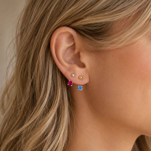 Colourful Illusion Birthstone Stud Earrings styled in a curated ear stack, perfect for everyday layering and mixing colours