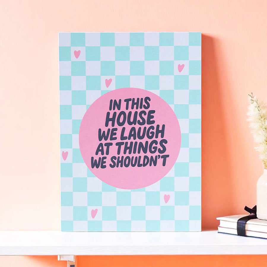 In This House We Laugh A5 art print with bold typography on pastel checkerboard background