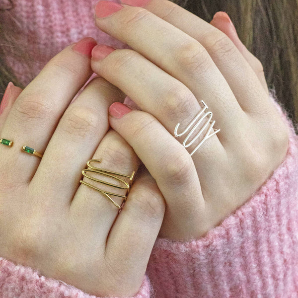 Model wears the gold plated JOY Stacking Rings Set on the left and silver plated JOY Stacking Rings Set on the right.