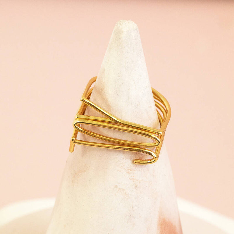 Image shows gold plated JOY Stacking Rings Set on a ring display holder.