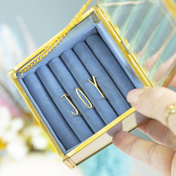 Image shows the gold plated JOY Stacking Rings Set in a blue jewellery box.
