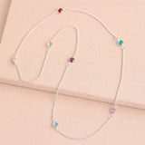 Silver long birthstone necklace with pink, purple and blue crystal accents, colourful layered jewellery with a modern finish.