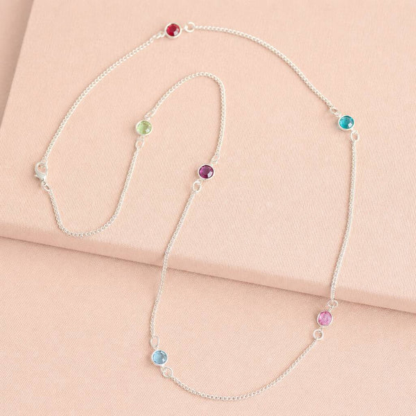 Silver long birthstone necklace with pink, purple and blue crystal accents, colourful layered jewellery with a modern finish.
