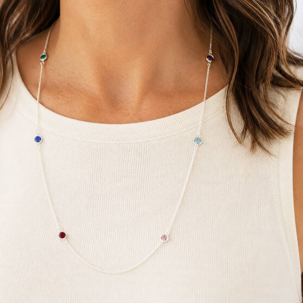 Long silver birthstone necklace styled with colourful crystal details, timeless jewellery for layering with everyday outfits.