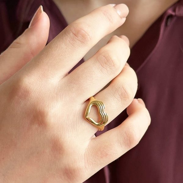 Image show model in burgundy top wearing love sign gold plated ring