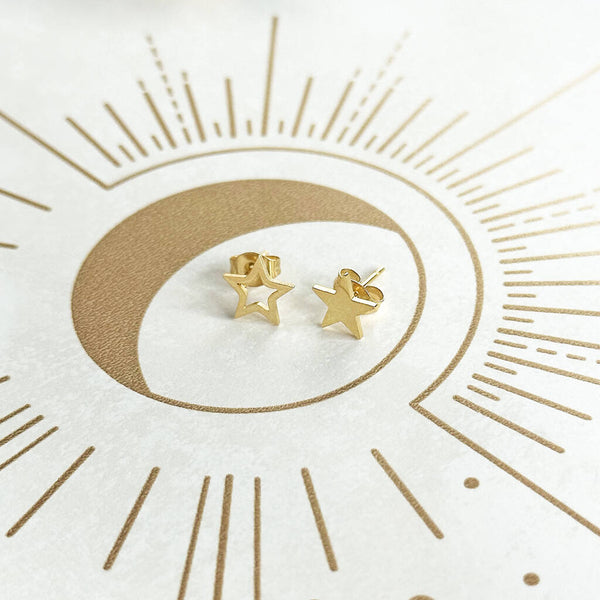 Image shows a pair of gold plated stud earrings, one sold star and one outline star
