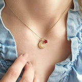 Model wears Moon and Birthstone Star Charm Necklace with January birthstone