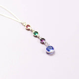 Silver birthstone drop necklace featuring four colourful crystal charms in a cascading pendant design
