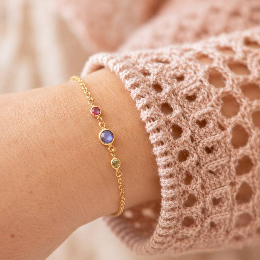 Gold plated birthstone bracelet with three colourful crystals, delicate personalised jewellery for stacking and everyday wear.