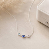 Silver birthstone link necklace with three bezel-set crystals on a fine chain, perfect for layered jewellery looks