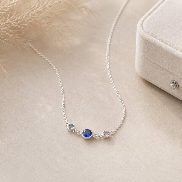 Silver birthstone link necklace with three bezel-set crystals on a fine chain, perfect for layered jewellery looks