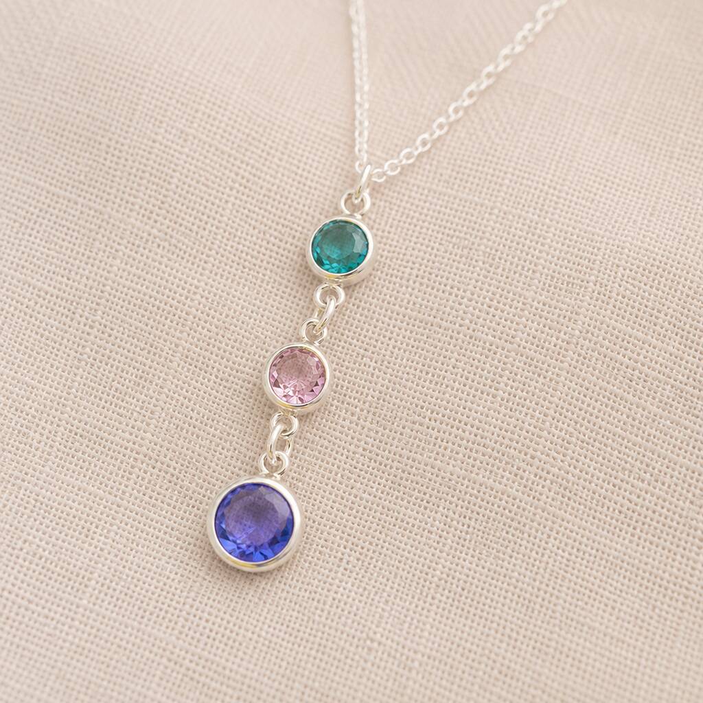 Silver birthstone pendant necklace featuring teal, blush pink and blue crystal drop charms