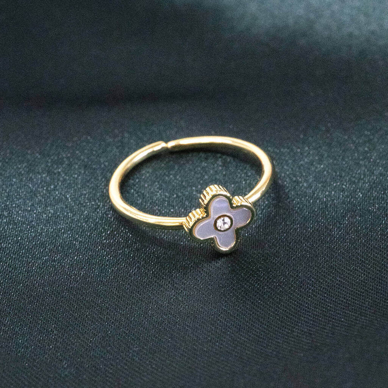 Image shows Mother of Pearl Adjustable Flower Ring on a green backdrop.