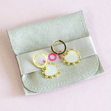 Image shows Mother of Pearl Heart Huggie Hoop Earrings on a JOY branded suedette pouch