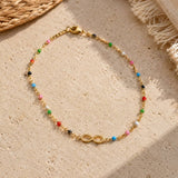 Colourful beaded infinity anklet with a gold plated infinity symbol, perfect for everyday summer styling
