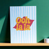 Retro typography A5 wall print with Ooh La La wording in yellow and red tones