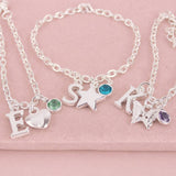 Silver children's charm bracelets featuring letter charms, colourful birthstones and fun motifs