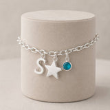 Silver charm bracelet with letter S, star pendant and aqua birthstone crystal for everyday wear 