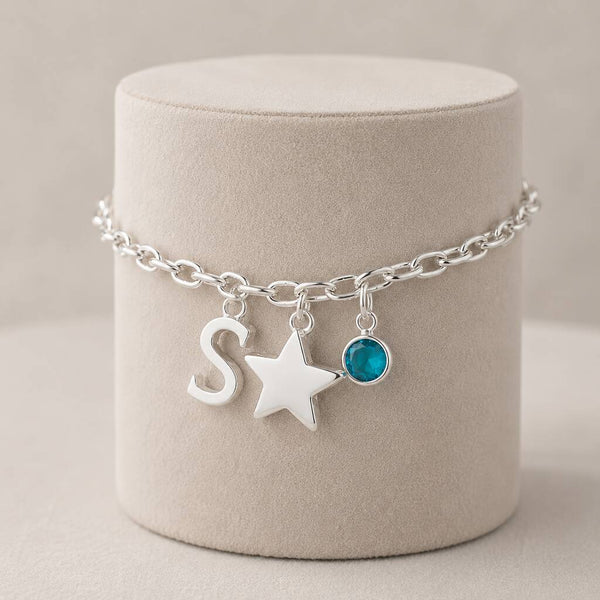 Silver charm bracelet with letter S, star pendant and aqua birthstone crystal for everyday wear 