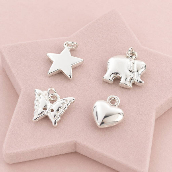 Silver charm collection featuring heart, butterfly, elephant and star charms for custom bracelets