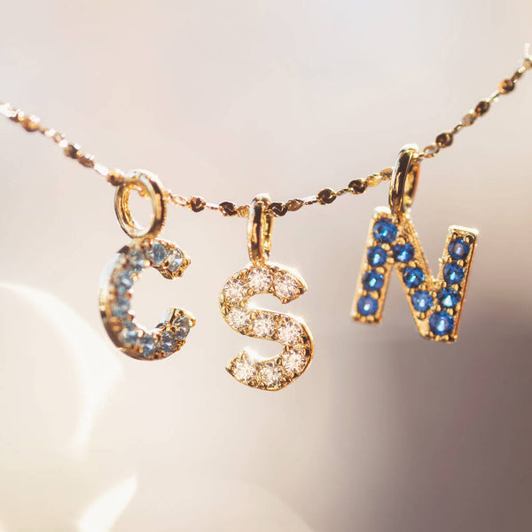 Family initial necklace with crystal birthstones in a delicate design