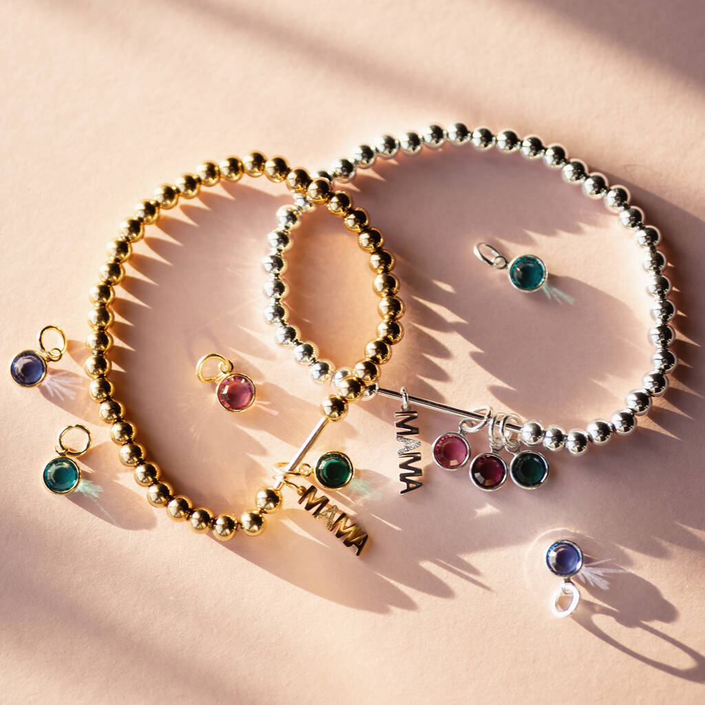 Family birthstone Mama charm bracelet featuring custom birthstones for children in silver and gold