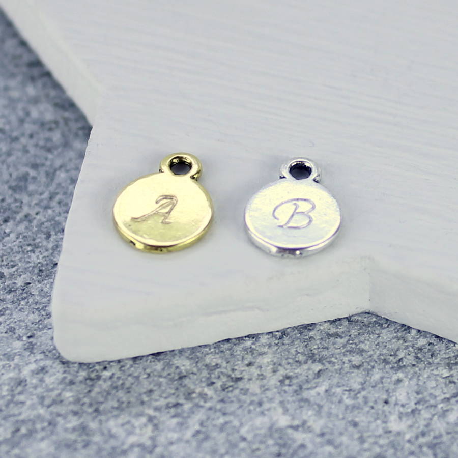 image shows a hand stamped gold initial disc - A and a silver disc - B