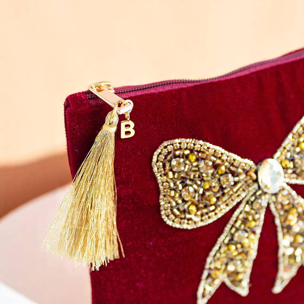 Luxury velvet pouch with hand-beaded bow design, crystal detail and JOY embroidery showing the personalised intital B
