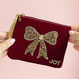 Red velvet pouch with gold bow beading, tassel zip charm and personalised initial tag