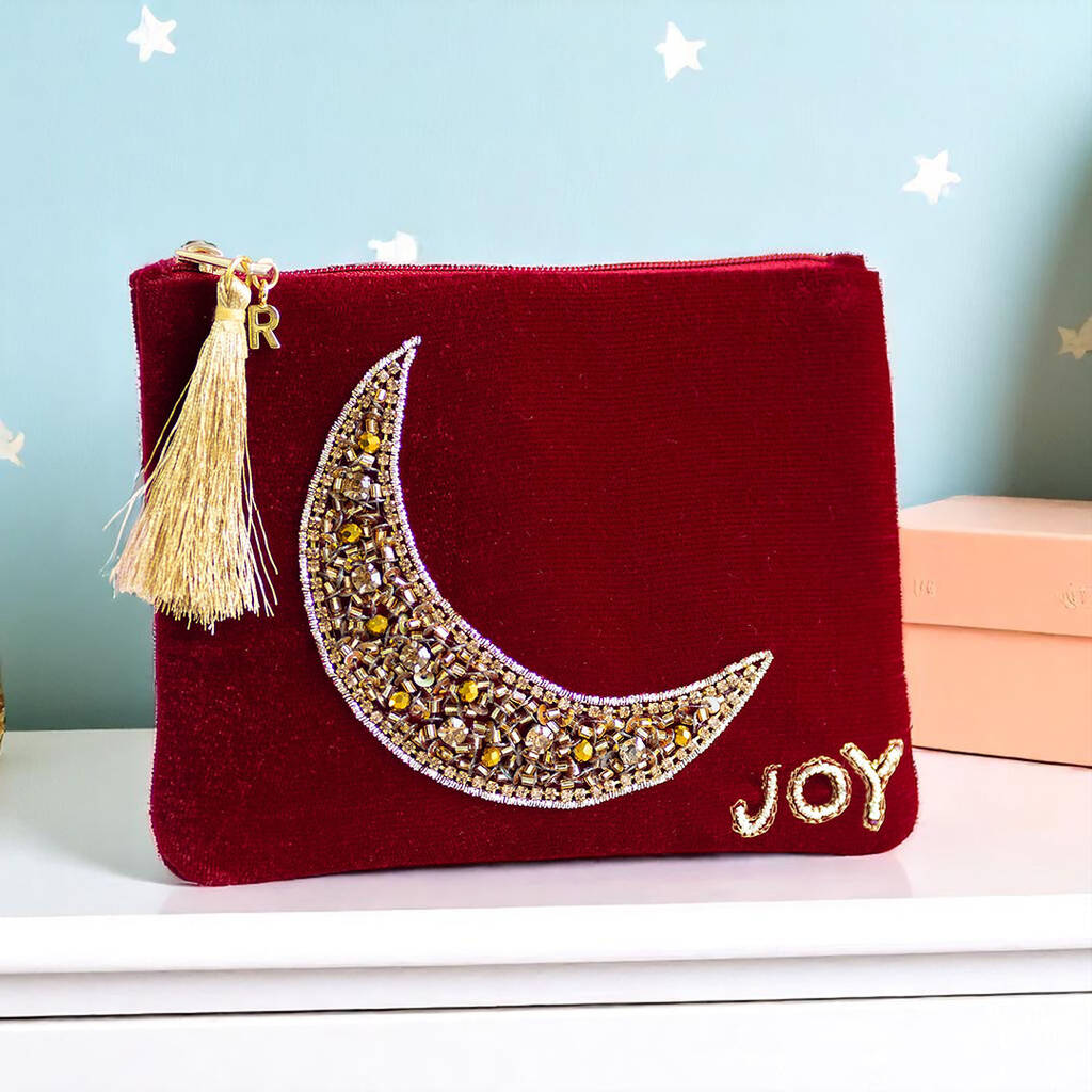 Velvet pouch with a hand-beaded gold moon, finished with a gold initial charm on the zip.