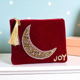 Velvet pouch with a hand-beaded gold moon, finished with a gold initial charm on the zip.